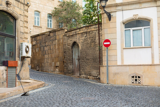 Photo of a stone street with a sign