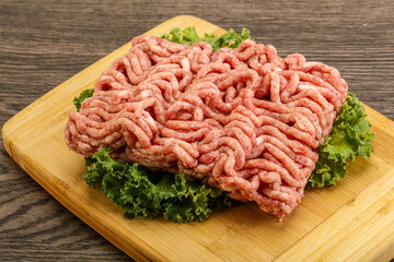 Raw pork minced meat over board