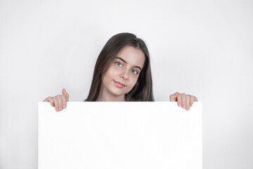 A portrait of a young girl draws attention away from a blank board.