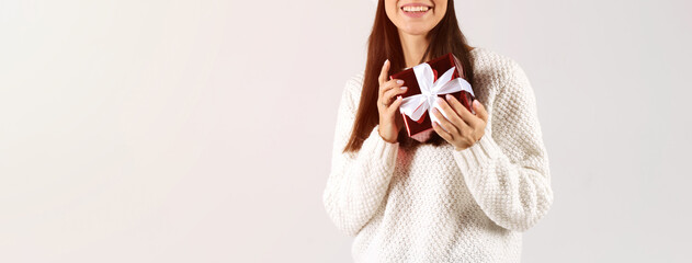 Close up woman's hands holding gift box. Christmas day concept banner. Empty space