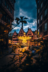 Christmas market on the Römerberg in Frankfurt Germany. Beautiful Christmas market in a historical setting with half-timbered houses. Romantic lighting