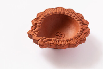Empty Terracotta oil lamp on white background.