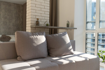 Sofa with pillows in room