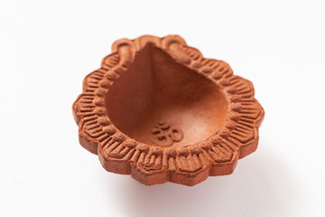 Empty Terracotta oil lamp on white background.