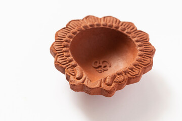 Empty Terracotta oil lamp on white background.