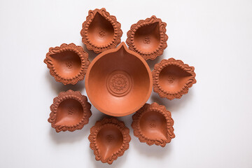 Empty Terracotta oil lamp on white background.