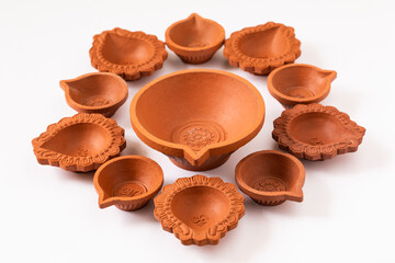 Empty Terracotta oil lamp on white background.