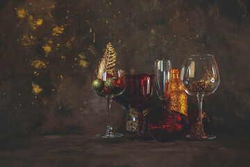 new year and christmas background with different glasses and toys for the christmas tree on a dark background