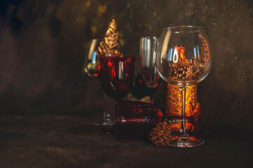 new year and christmas background with different glasses and toys for the christmas tree on a dark background