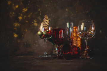 new year and christmas background with different glasses and toys for the christmas tree on a dark background