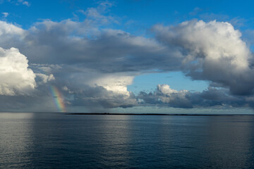 Naklejka na ściany i meble Rainbow and clouds over the Gulf of Mexico as seen from Cuba