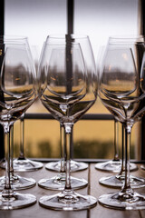 Wine glasses in front of a window at a winery.