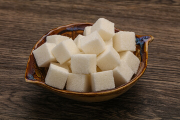 Refined white sugar cubs in the bowl