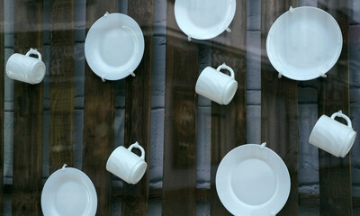 White plates and mugs on wooden boards