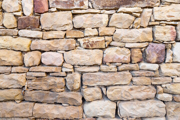 Wall of stones of different sizes, texture.