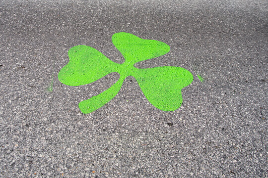 Saint Louis, MO—Mar 15, 2019; green shamrock temporarily painted on road to mark Saint Patrick’s day parade route and 5K race downtown