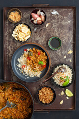A high angle view of home made vegan Indonesian jackfruit rendang served with rice and accompaniments