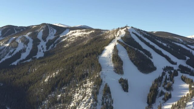 drone shot of empty ski resort during winter before it opens during sunrise