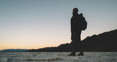 Male traveler enjoying sunset in valley
