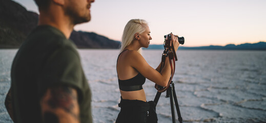 Focused female shooting sunset in desert