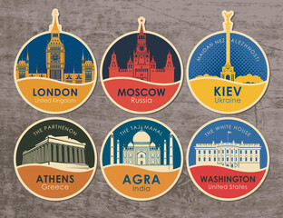 Set of stickers with the sights of the capitals of various countries. Vector illustration on the theme of travel with round emblems on a wooden background. UK, Russia, Ukraine, Greece, India, USA © paseven