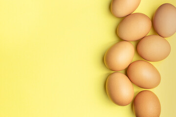 Chicken eggs on the yellow background
