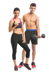 Athletic man and woman with dumbbells on the white background