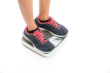 Sports men feet standing on weighing scale on white background.