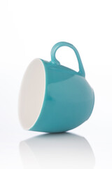 Teal color tea cup on white background © krishna