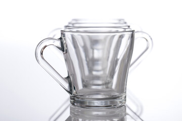 Empty glass tea cups arranged on white background