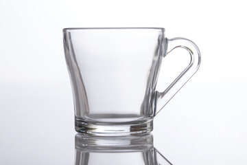 Empty glass tea cups arranged on white background