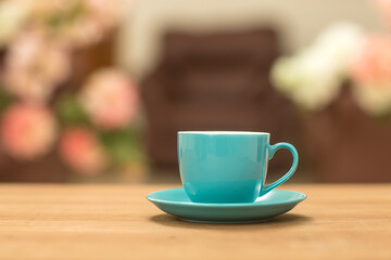 Fototapeta na wymiar Teal tea cups on table at home.