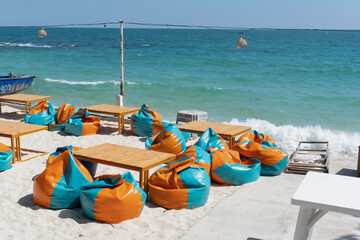 Bean bags and table on the beach.