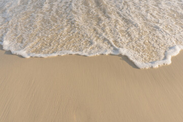 Soft wave of sea on empty sandy beach Background with copy space