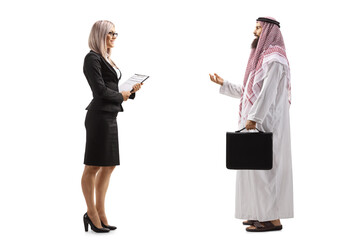 Full length profile shot of a businesswoman holding a document and talking to a saudi arab businessman