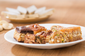 Plates of Oriental sweets on table.