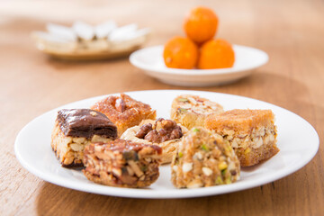 Plates of Oriental sweets on table.