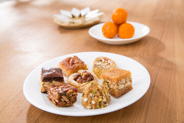 Plates of Oriental sweets on table.