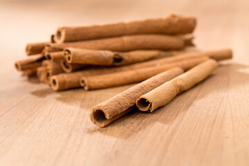 cinnamon sticks on wooden table.