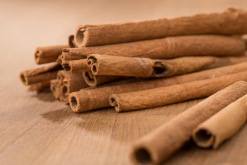 cinnamon sticks on wooden table.