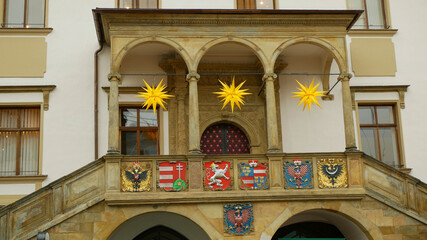 City Hall tower and historic buildings in Olomouc, national coats arms blazon crest shields of...