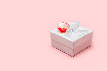 Valentine's Day. Gift on a pink background. Beautiful holiday packaging. Postcard.