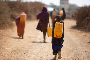 Woman walking home after food distribution during deadly drought in Somalia