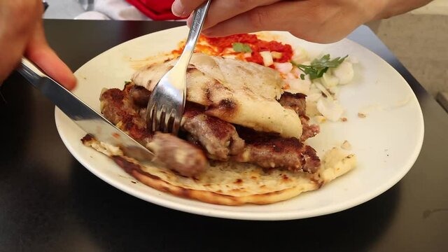Cevapcici or Cevapi, Bosnian dish prepared on the barbecue and served with Lepinja bread. Popular Balkan dish.