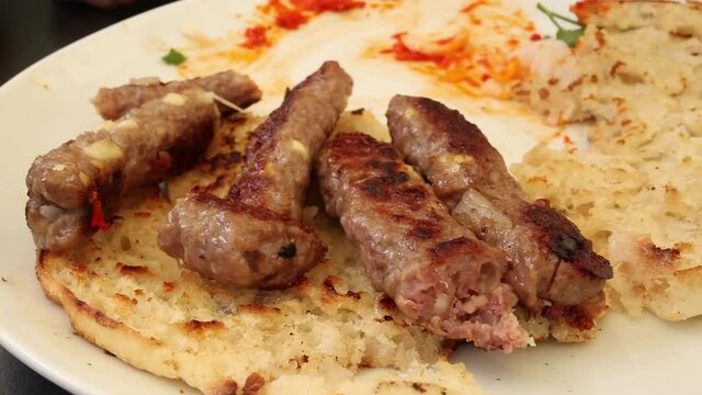 Cevapcici or Cevapi, Bosnian dish prepared on the barbecue and served with Lepinja bread. Popular Balkan dish.
