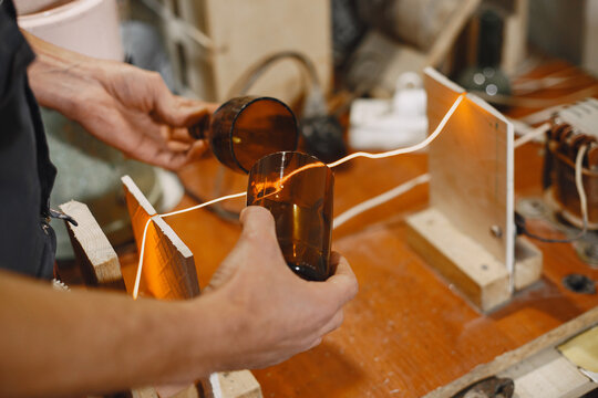 Hand worker with empty bottle. Man's hand close-up.The concept of production.