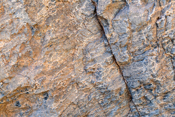 Diagonal crack through a rock on the wall of Titus Canyon in Death Valley National Park, California, USA