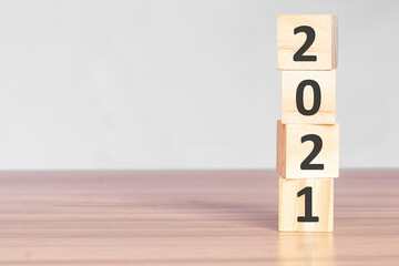 Wooden blocks stack with numbers 2021 The beginning of the new year on the table. Happy New Year...