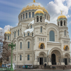 Fototapeta na wymiar Front view of the facade of the Naval Cathedral in Kronstadt, Russia against a blue autumn sky