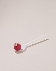 Creative concept made with white spoon and Christmas decoration. Minimal composition. New Year background.